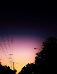 Low angle view of electricity pylon against sky