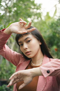 Portrait of young woman looking at camera