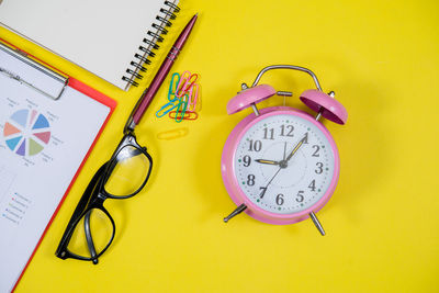 High angle view of clock on table