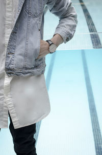 Man standing by swimming pool