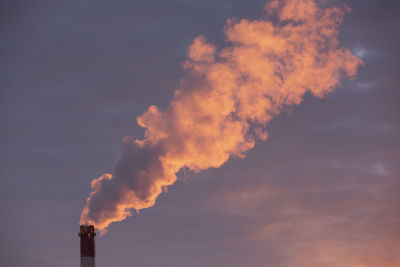 Low angle view of smoke stack against sky