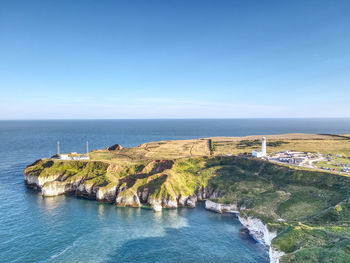 Scenic view of sea against clear blue sky