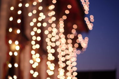 Defocused image of illuminated christmas lights at night