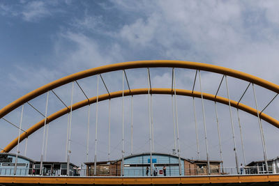 Low angle view of suspension bridge against sky