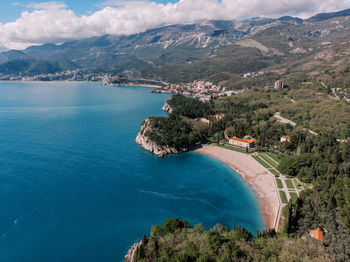 High angle view of sea and mountains against sky