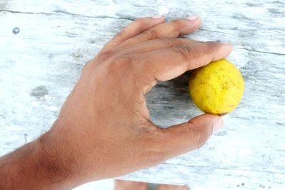 Close-up of man holding fruit