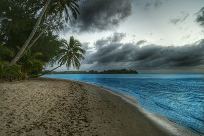 Scenic view of sea against cloudy sky