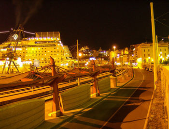 Illuminated city against sky at night