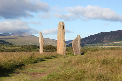 Built structure on field against sky