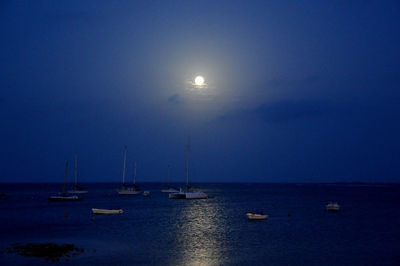 Sailboats in sea against clear sky