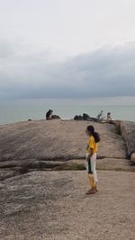Man standing on beach against sky