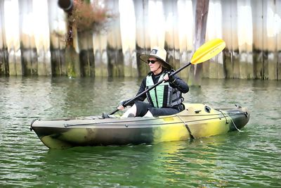 Portrait of man with umbrella on boat in water