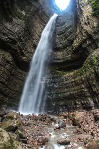 Low angle view of waterfall in forest