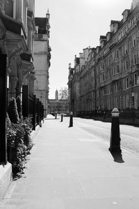 Street amidst buildings in town against sky