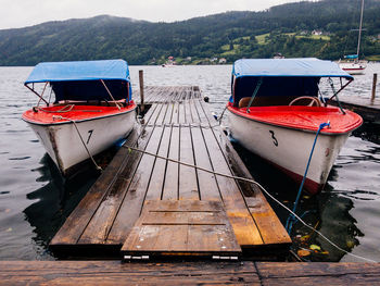 Boat moored on shore at lake