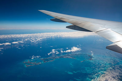 Cropped image of airplane wing against sky