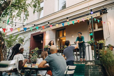 Multi-ethnic young friends enjoying garden party