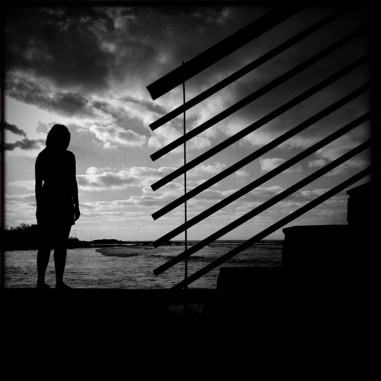 silhouette, sky, built structure, architecture, cloud - sky, sea, building exterior, cloud, men, standing, horizon over water, water, beach, lifestyles, full length, walking, rear view, cloudy