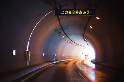 Empty road in illuminated tunnel