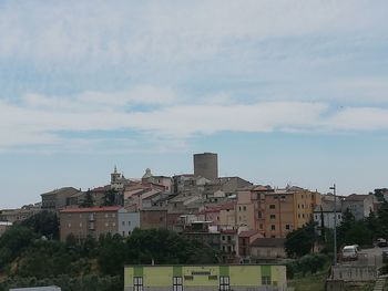 Buildings in town against sky