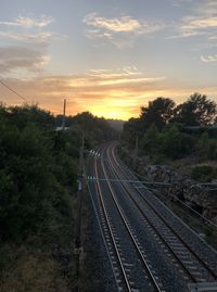 High angle view of railroad tracks against sky during sunset