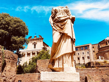 Low angle view of statue against historic building