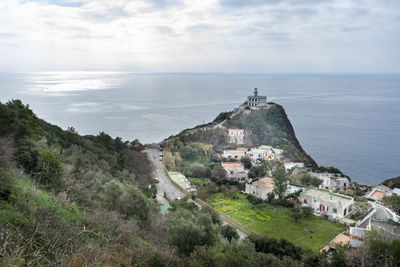 High angle view of townscape by sea against sky