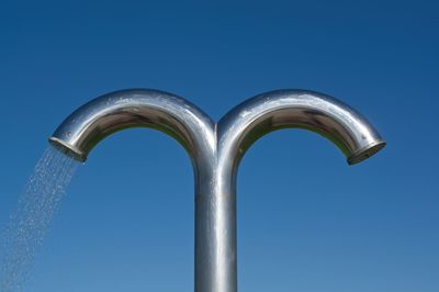 Low angle view of sculpture against blue sky