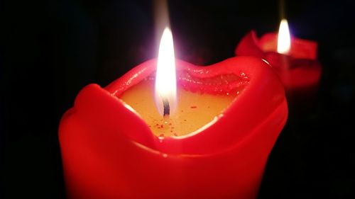 Close-up of candle burning in room