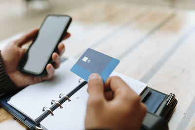 Man using credit card to pay bills