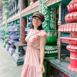 Portrait of young woman standing in store