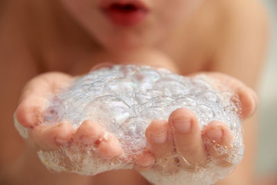 Close-up of children plays with foam