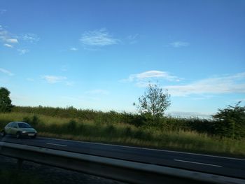 Car on road against blue sky