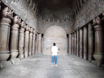 Rear view of man standing in old ruin