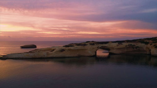 Scenic view of sea against sky at sunset