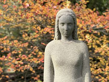 Low angle view of statue against trees