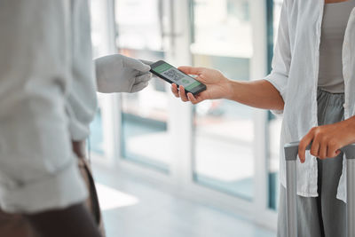 Midsection of man using mobile phone