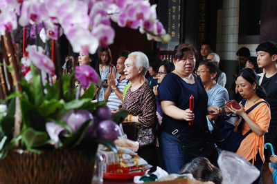 Group of people holding food outdoors