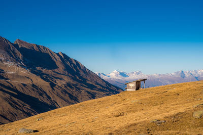 Scenic view of mountains against blue sky