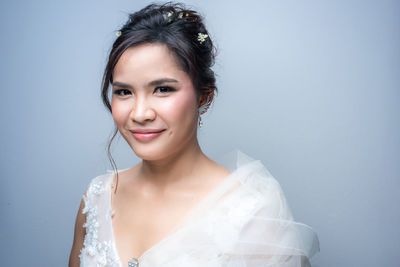 Portrait of a smiling young woman over white background