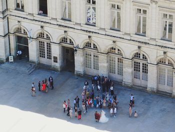 Tourists looking through window