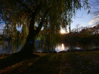 Scenic view of lake against sky at sunset