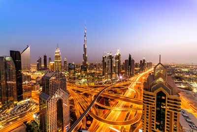 High angle view of city lit up at night