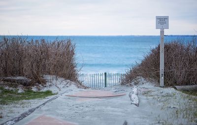 Scenic view of beach against blue sky