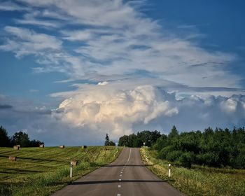 Idyllic countryside road with impressive clouds ahead