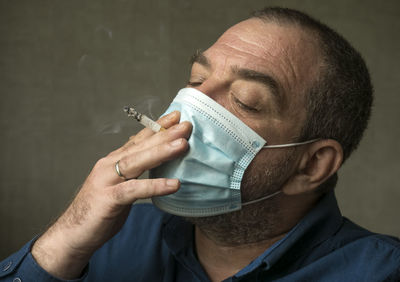 Close-up portrait of a man holding hands