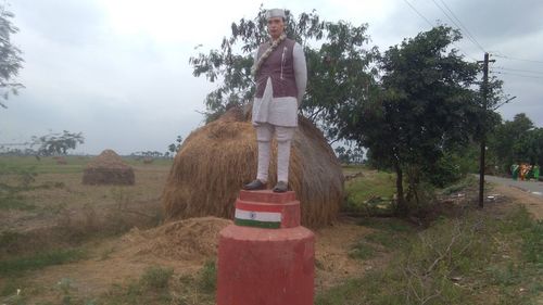 Full length of man standing on field against sky