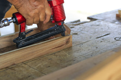 Cropped hand working on wood