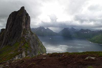 Scenic view of sea and mountains against sky