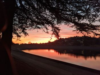 Scenic view of lake against orange sky